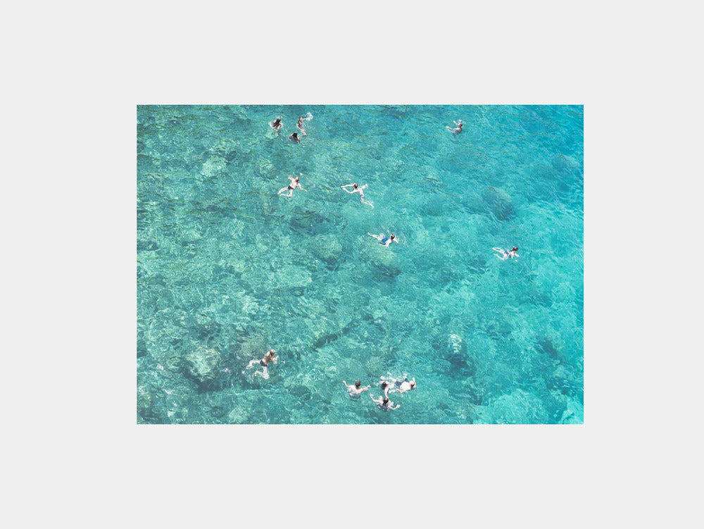 Swimmers in Turquoise Water