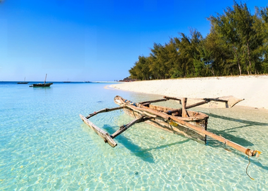 Traditional fisherman boat lying near the beach in clear water